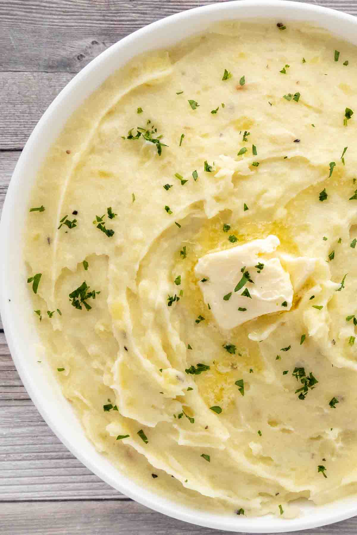 Garlic mashed potatoes in a white bowl.