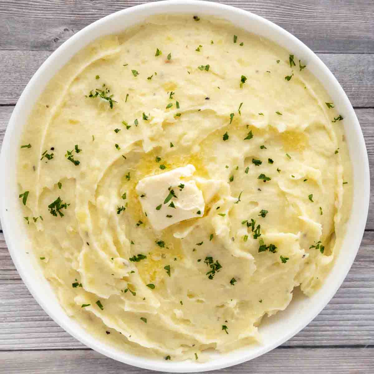 Garlic mashed potatoes in a white bowl.