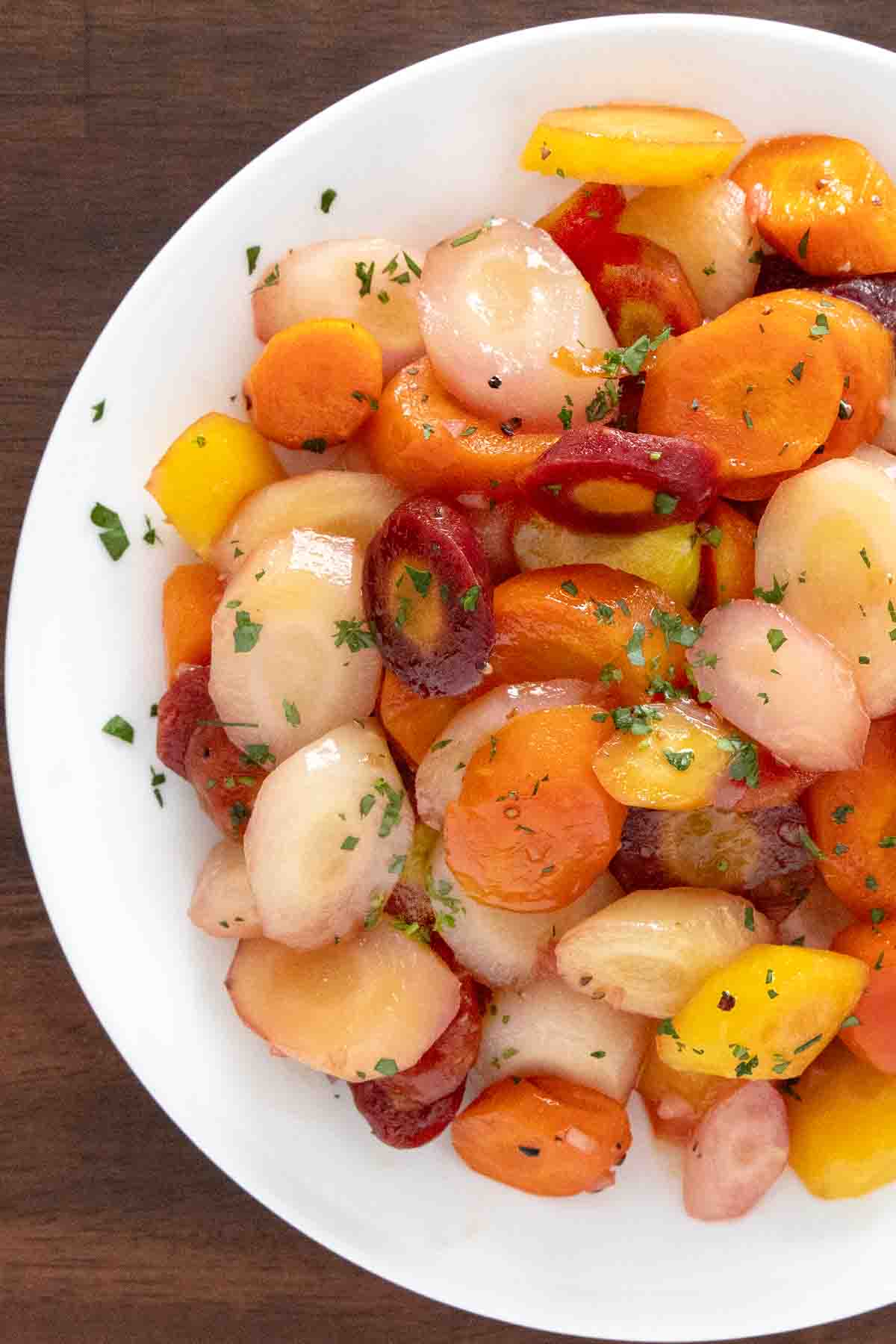 Honey glazed carrots in a white. bowl.