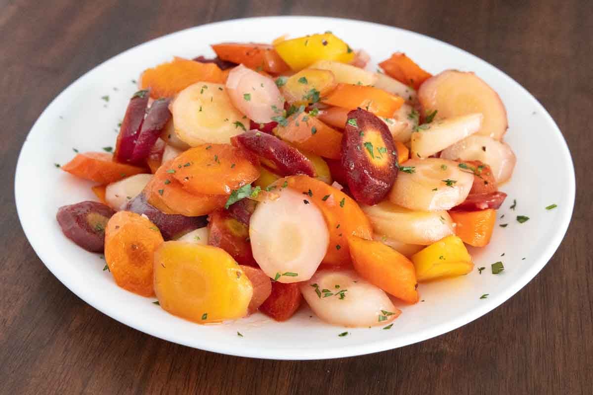 Honey glazed carrots in a white. bowl.