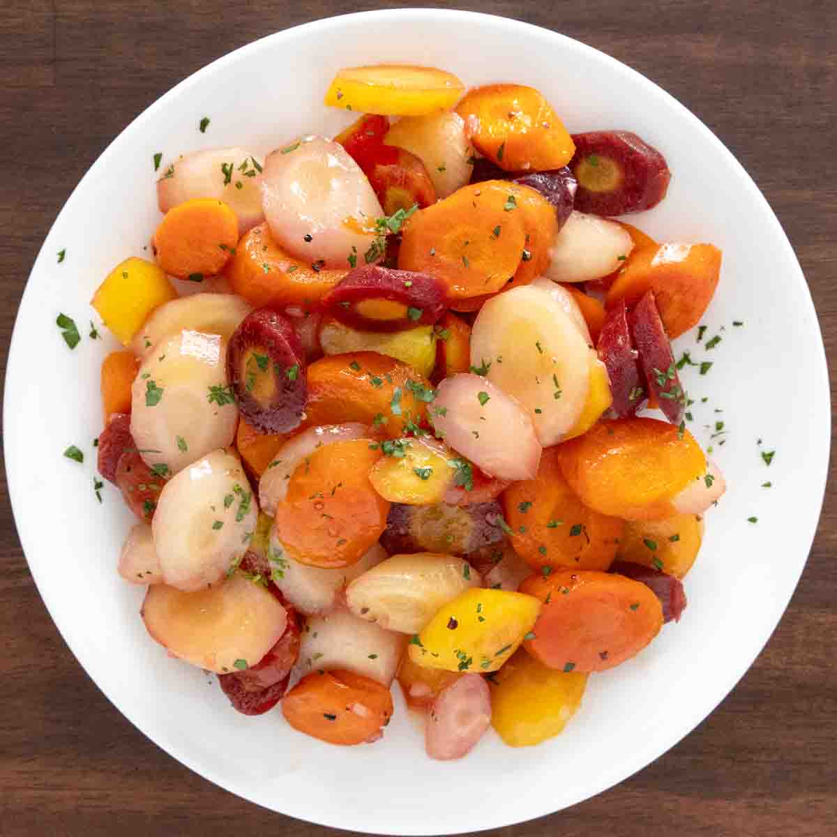Honey glazed carrots in a white. bowl.