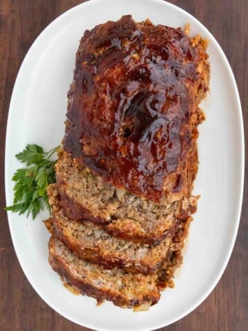 Lipton French onion meatloaf sliced on white platter.