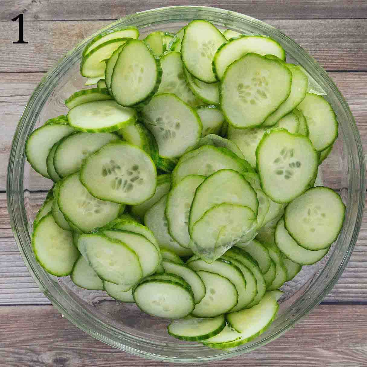 Sliced English cucumbers in a glass bowl.