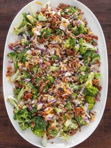 Broccoli salad on a white platter.
