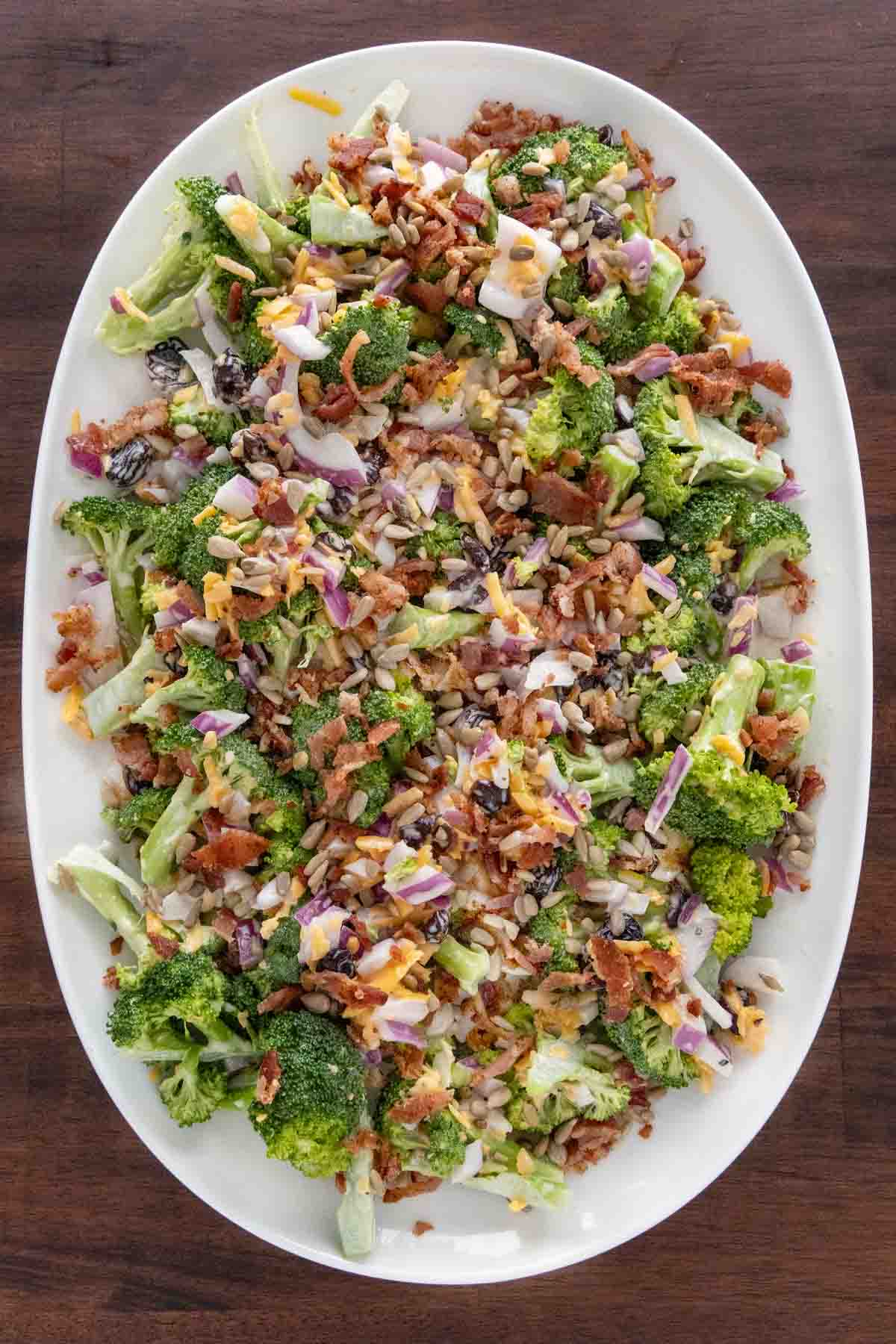 Broccoli salad on a white platter.
