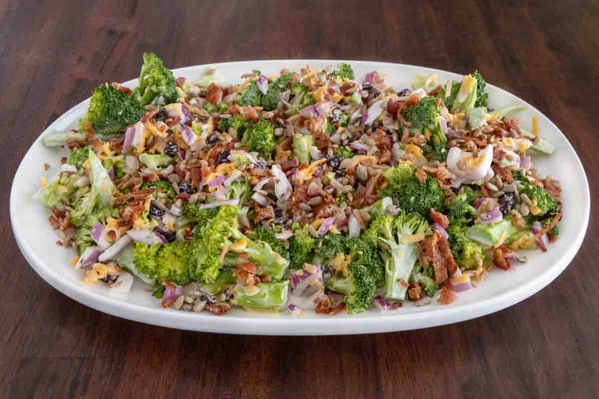 Broccoli salad on a white platter.