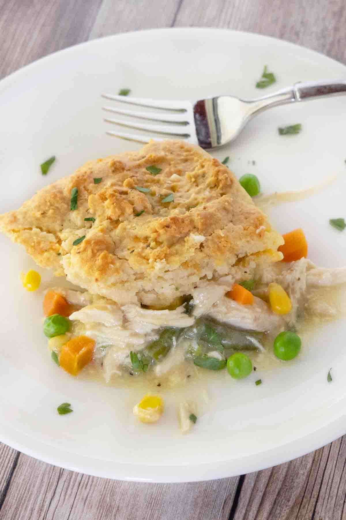 Chicken cobbler on a white plate with a fork.