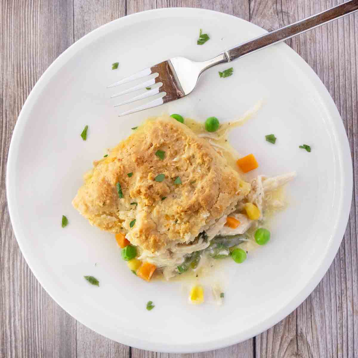 Chicken cobbler on a white plate with a fork.
