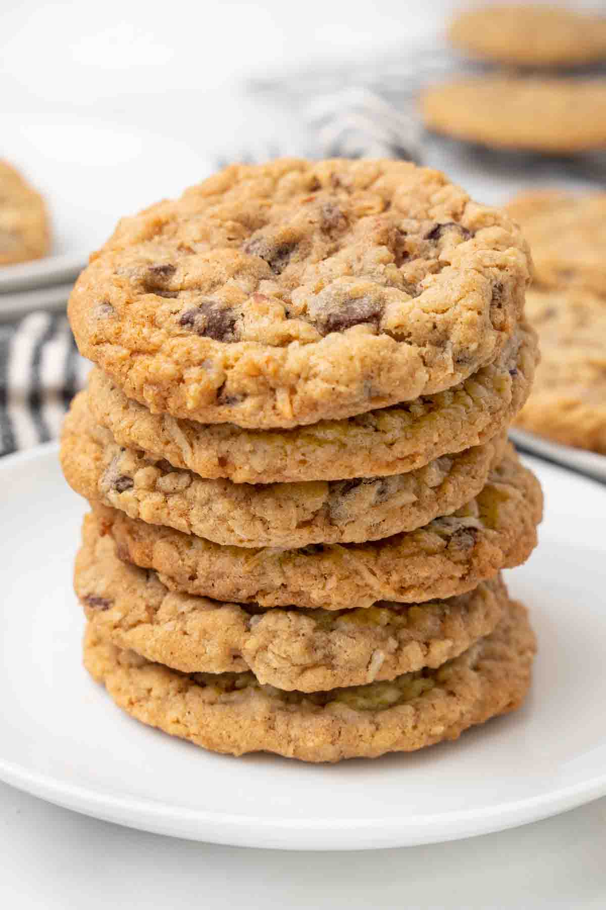 Stack of cowboy cookies on a white plate.