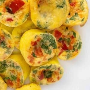 Egg bites stacked on a white platter.