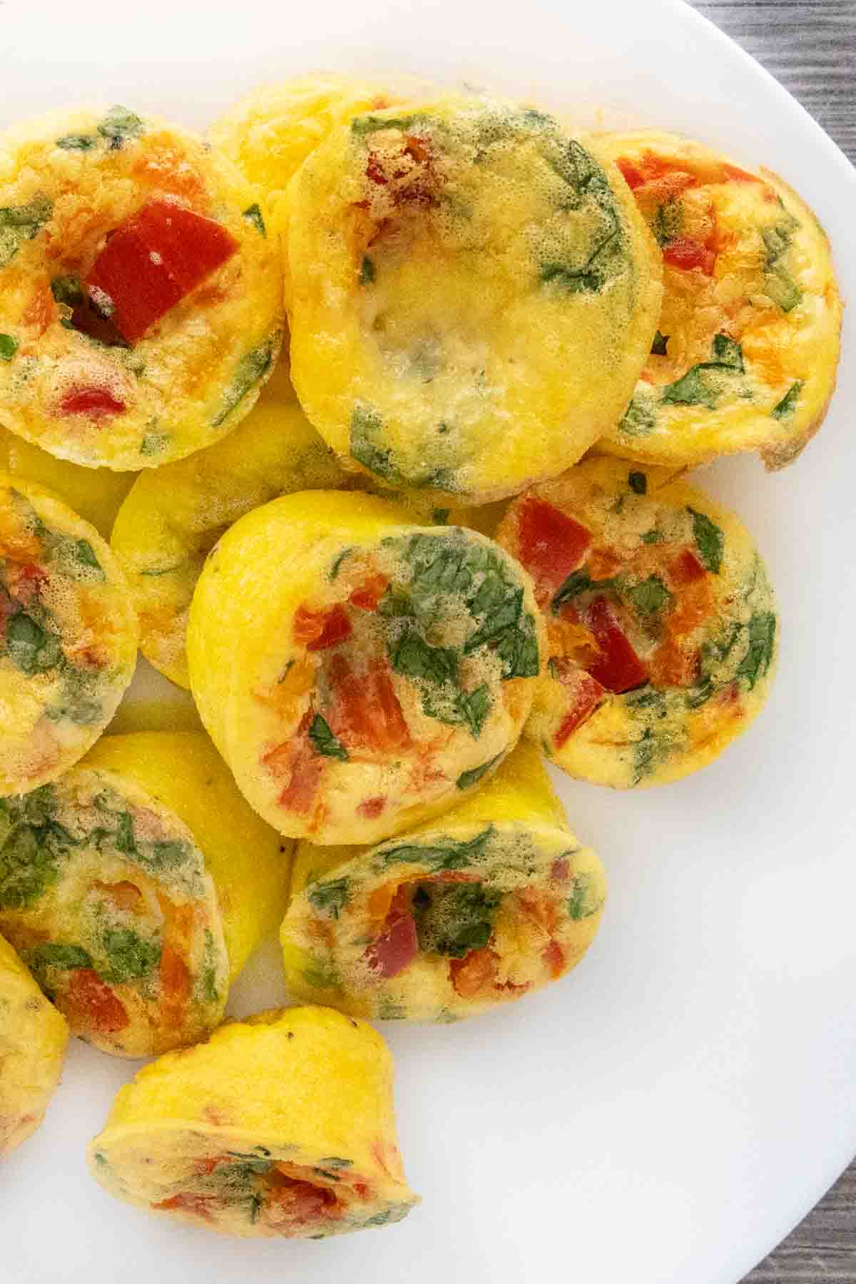 Egg bites stacked on a white platter.