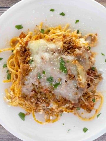 Portion of million dollar spaghetti on a white plate.