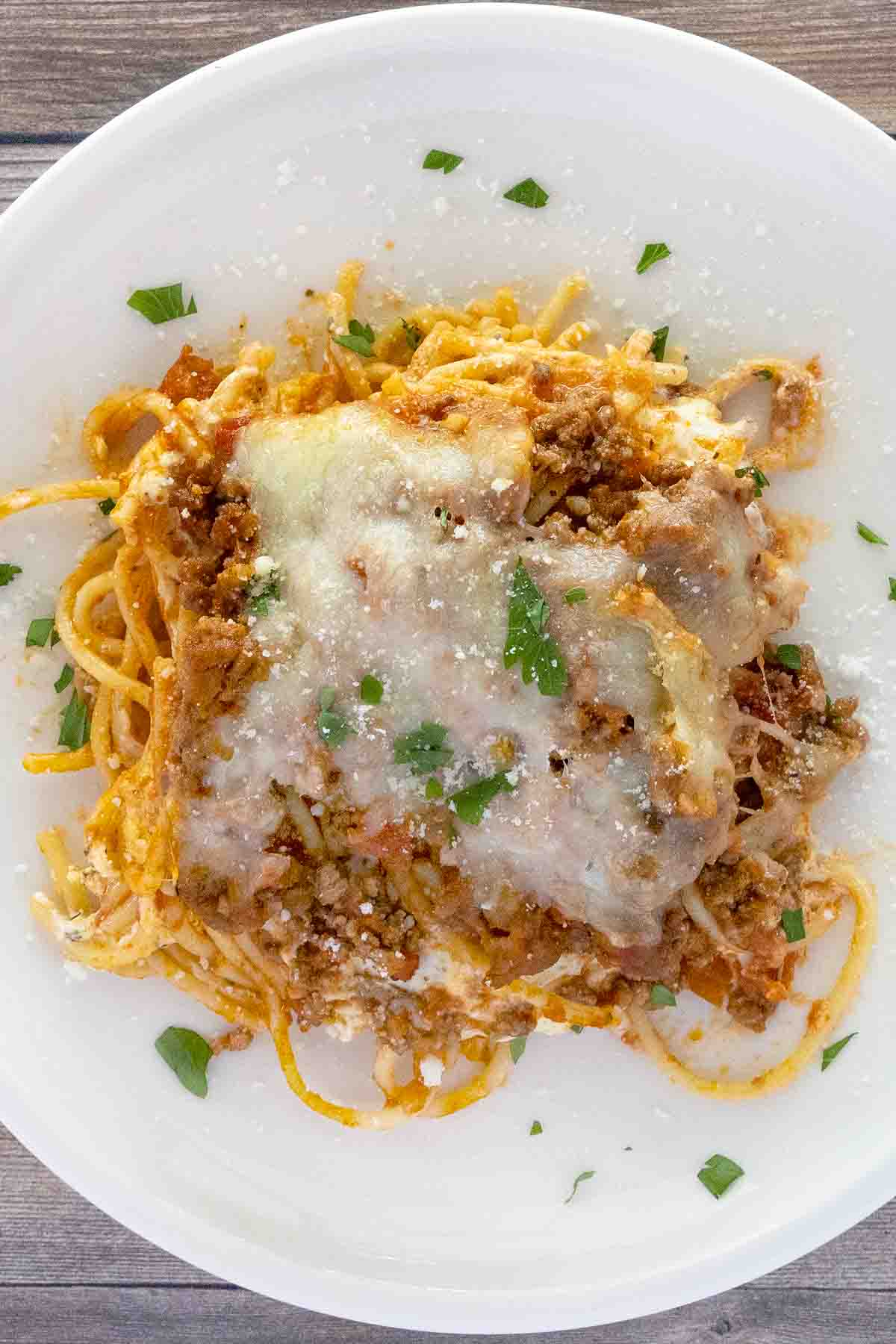 Portion of million dollar spaghetti on a white plate.