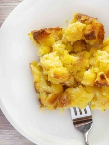 Pineapple stuffing with a fork in it on a white plate.