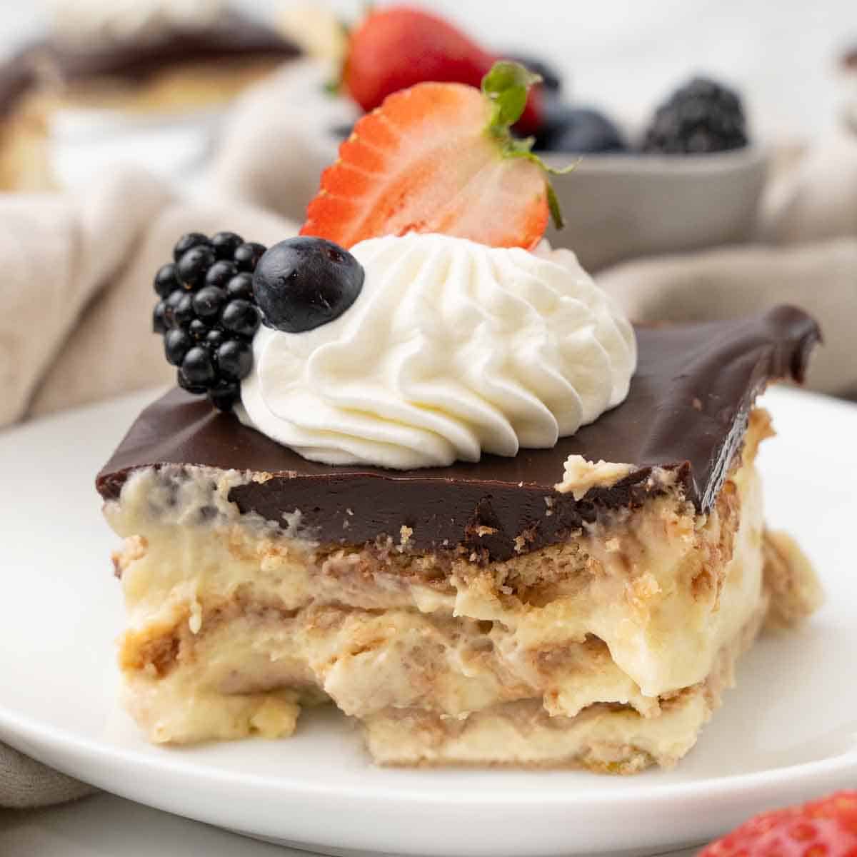 Slice of eclair cake on a white plate.