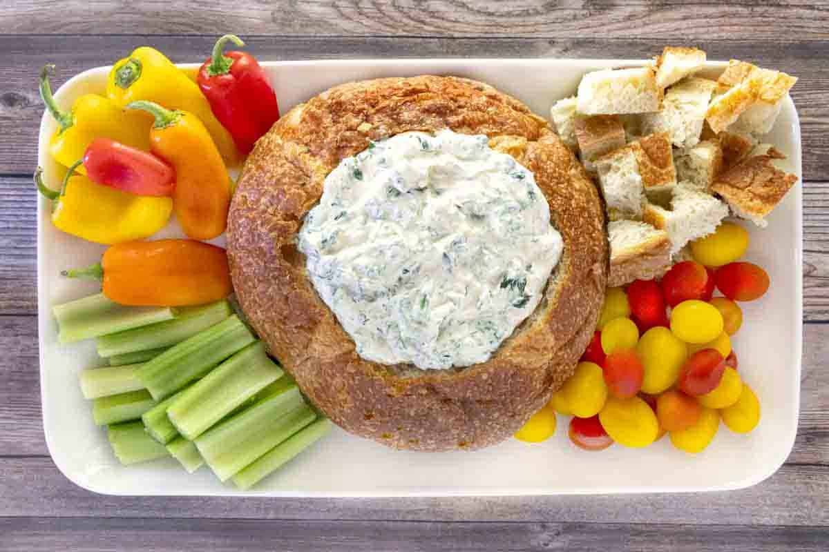 Knorr spinach dip in a bread bowl with veggies and bread cubes .