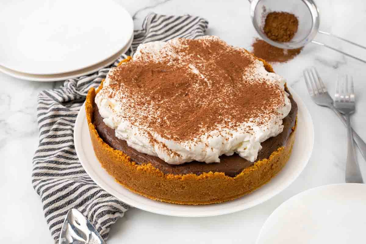 Whole Mississippi Mud Pie with a black and white striped napkin.