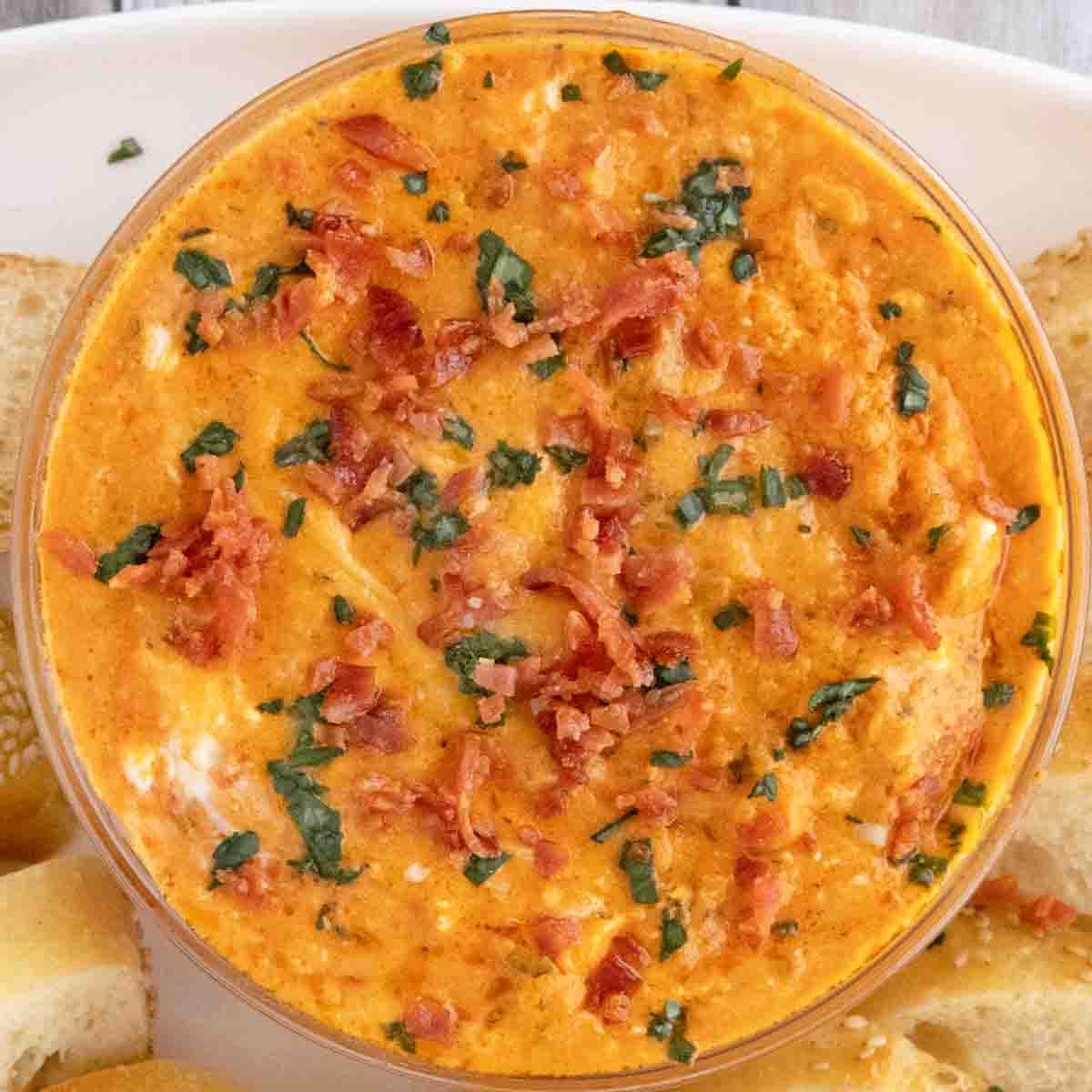 Pizza dip in a glass bowl.