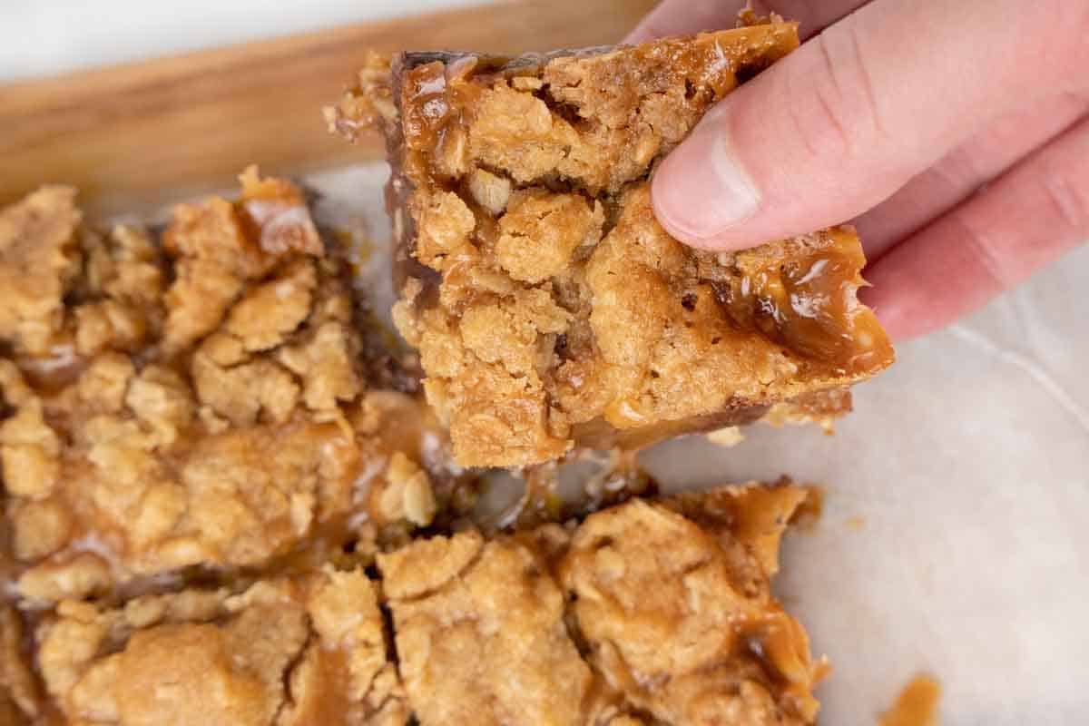 Handing picking up a carmelitas from the tray.