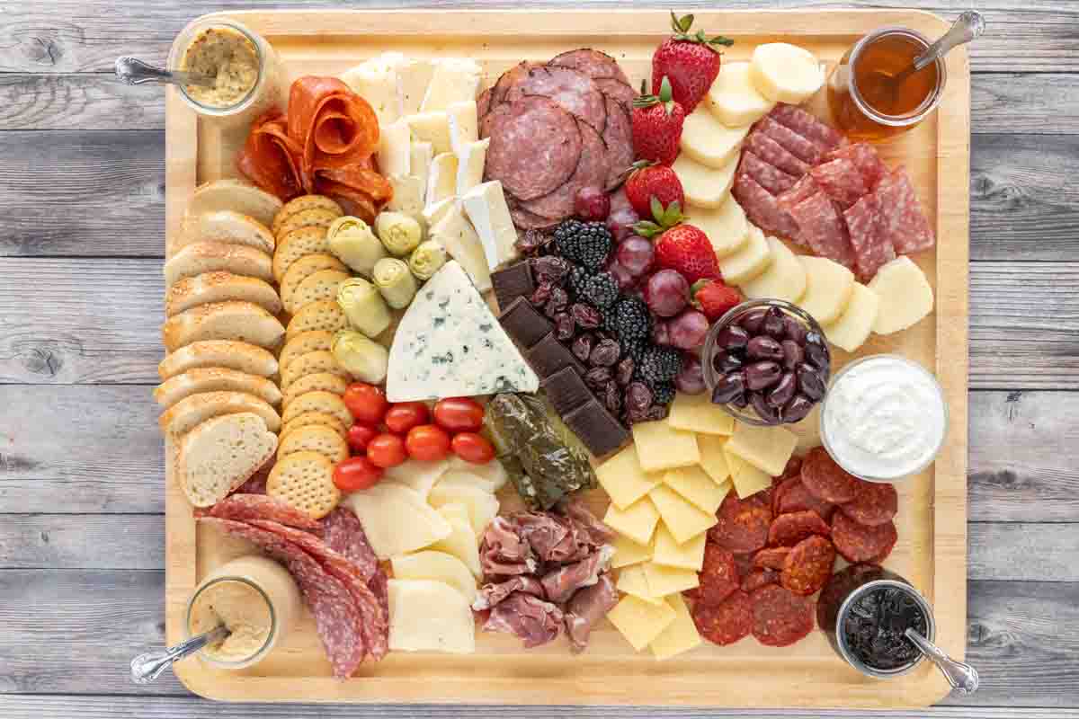 Charcuterie set out on wooden cutting board.