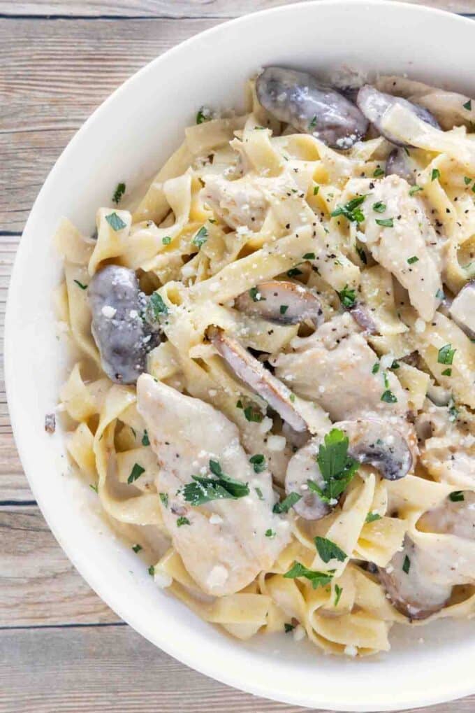 Chicken Alfredo in a white bowl.