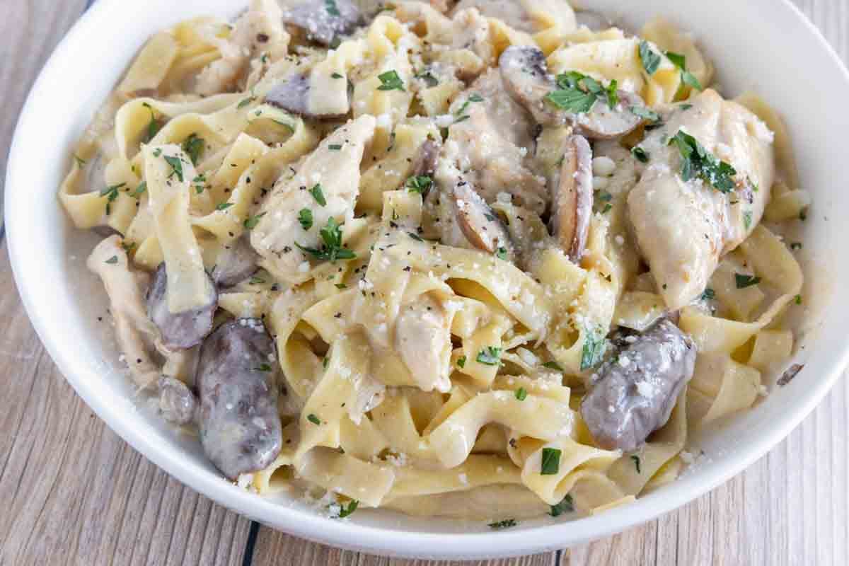 Chicken Alfredo in a white bowl.
