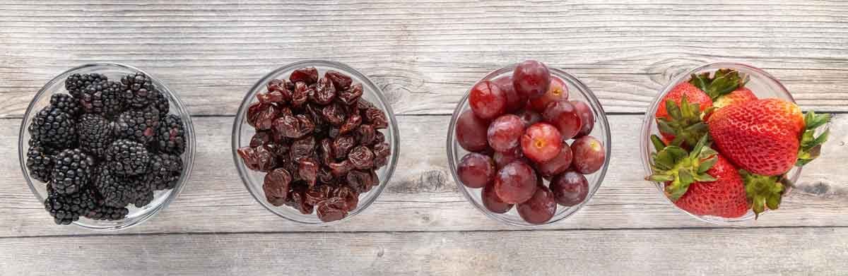 fruit in four small bowls.