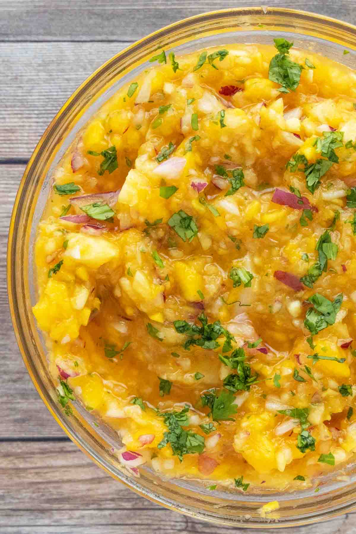 Mango salsa in a glass bowl.