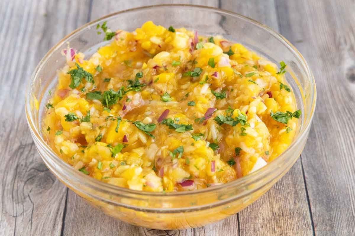 Mango salsa in a glass bowl.