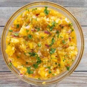 Mango salsa in a glass bowl.