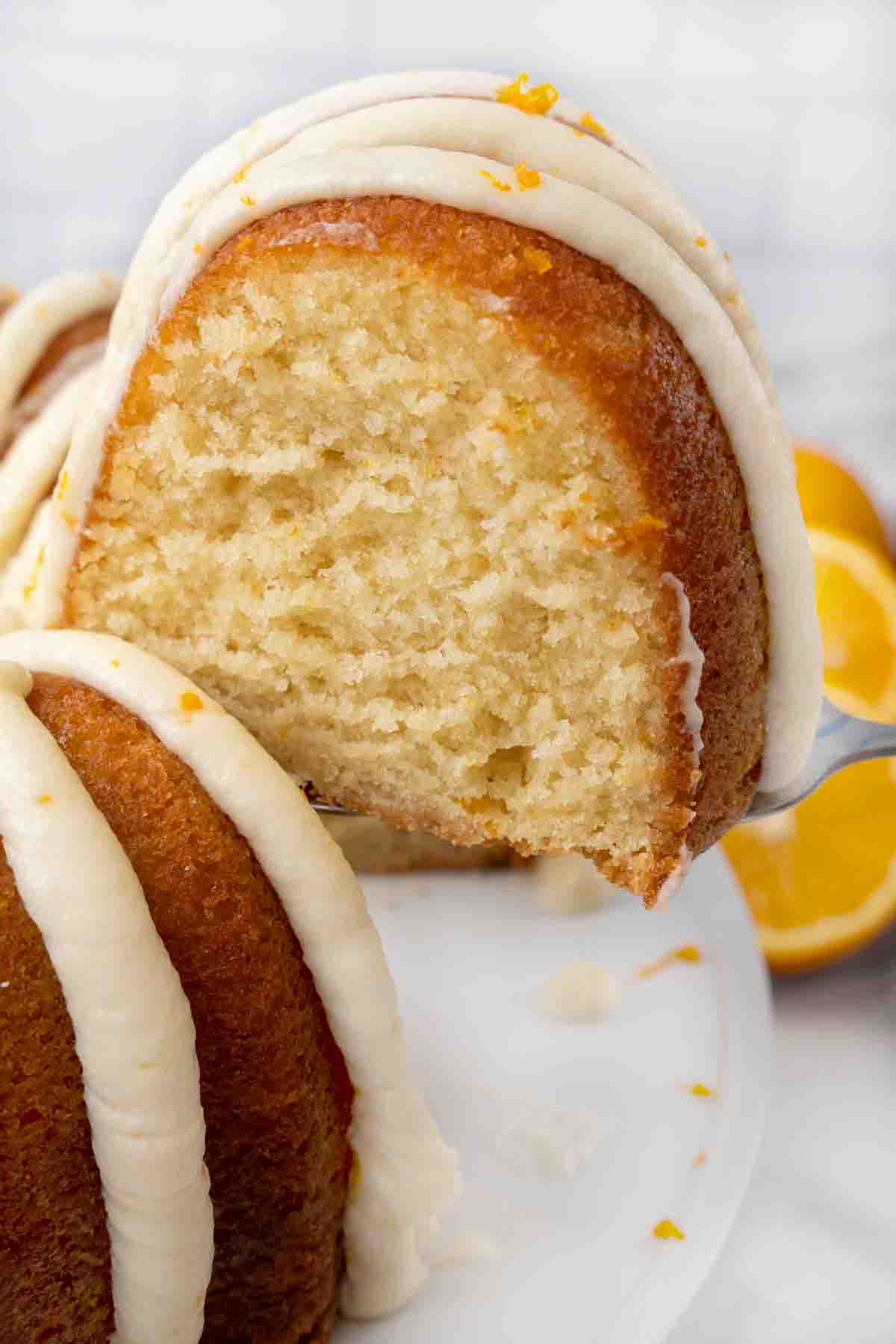 Slice being taken out of an orange cake.