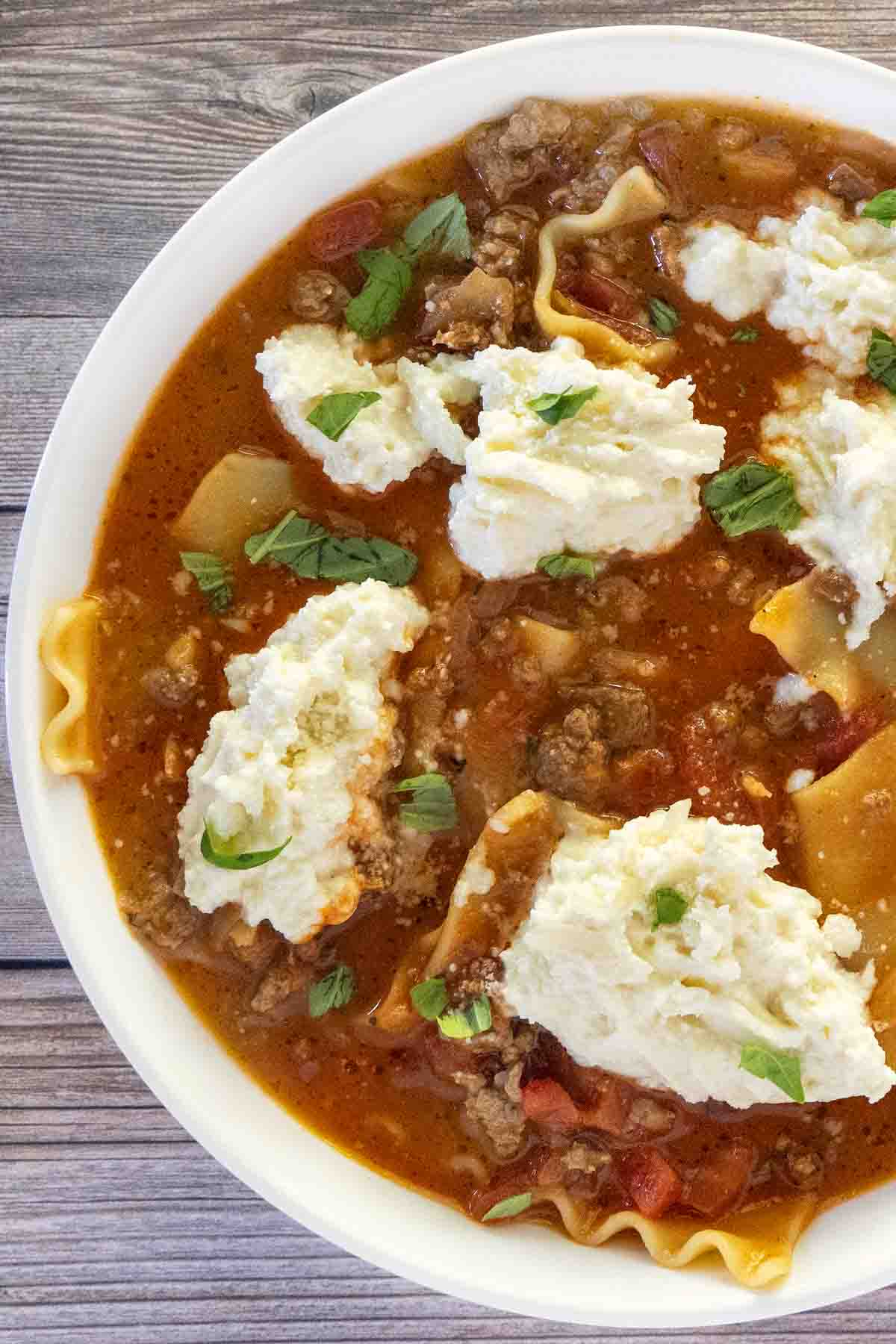 Lasagna soup in a white bowl.