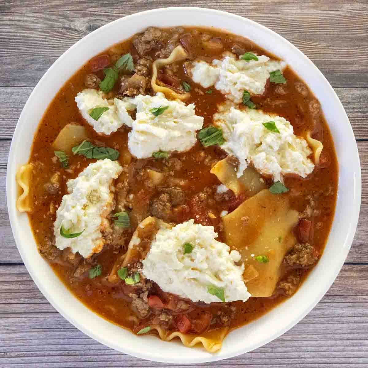 Lasagna soup in a white bowl.