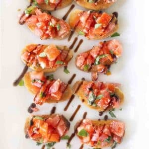Bruschetta on a white platter.