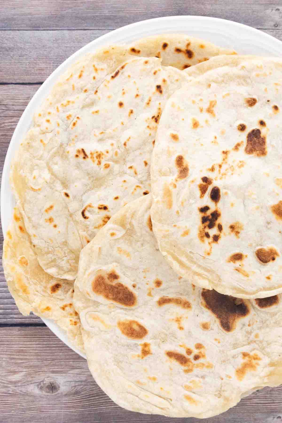Flour tortillas on a white plate.