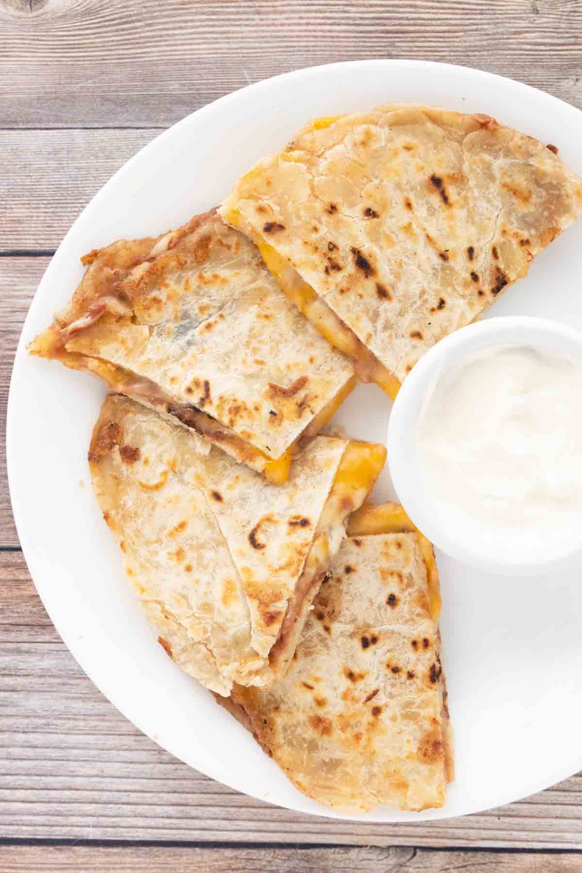 Cheese quesadillas on a white plate.