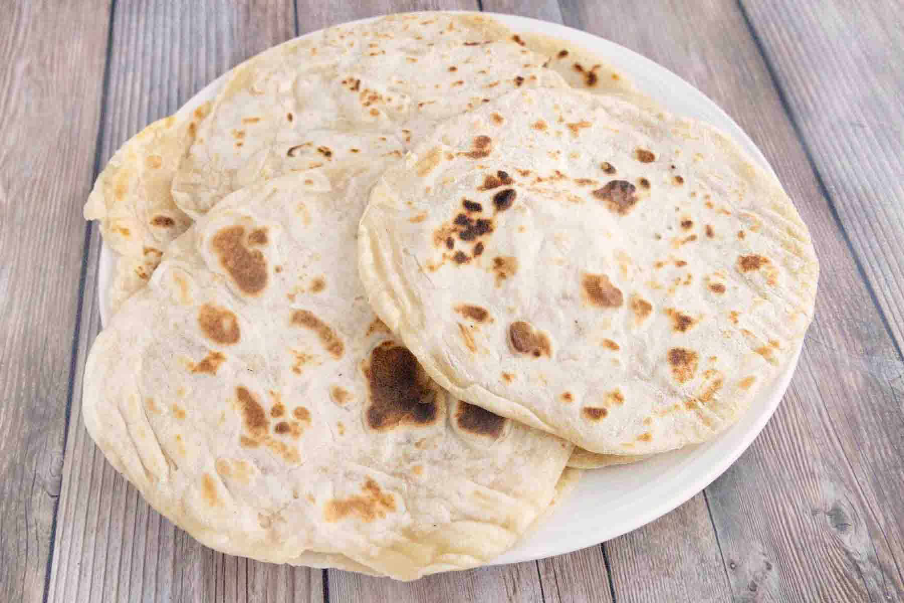 Flour tortillas on a white plate.