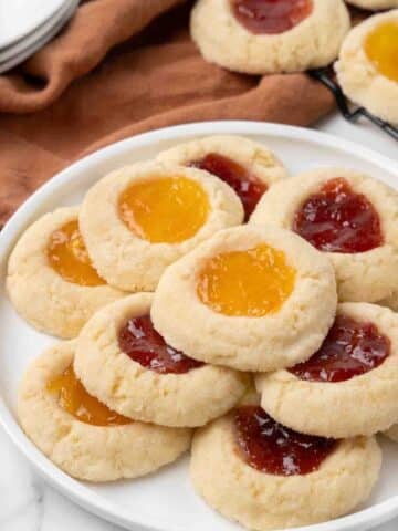 Thumbprint cookies on a white platter.