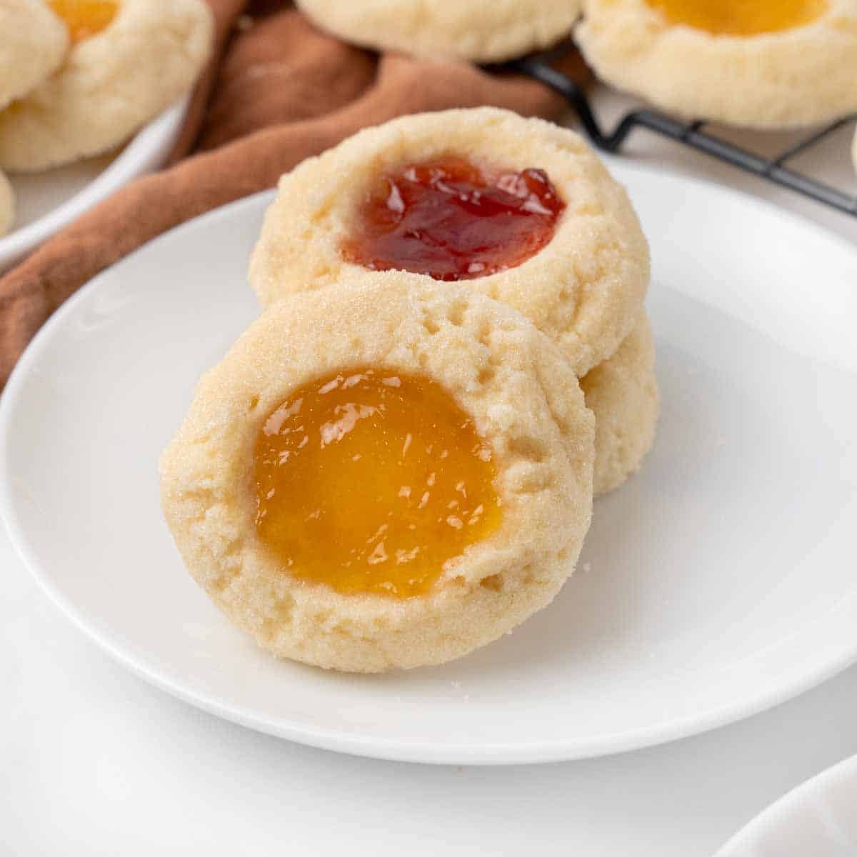 Thumbprint cookies on a white plate.
