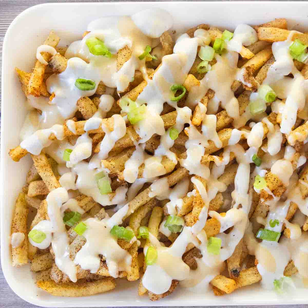 Louisiana voodoo fries on a white platter.