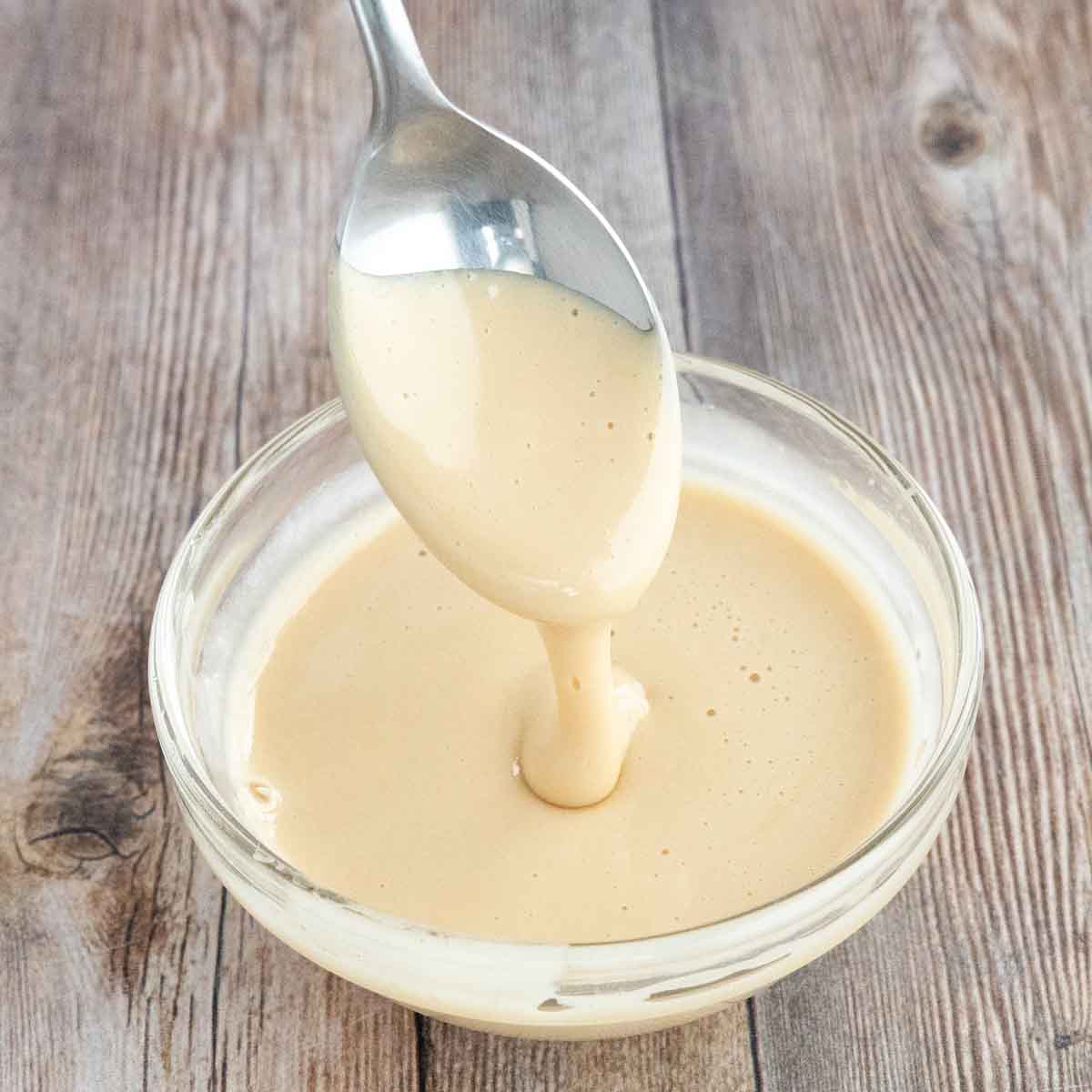 Whipped honey in a bowl with a spoon coming out.