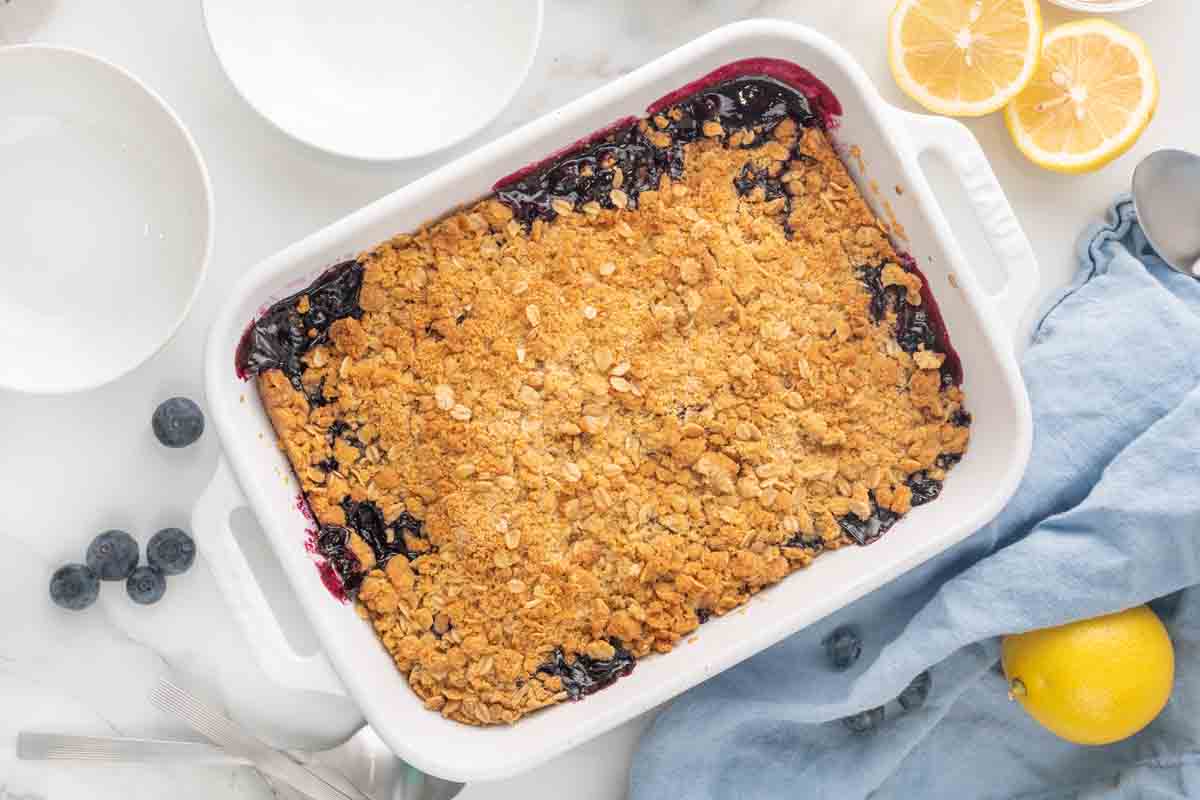 blueberry crumble in a white baking dish.