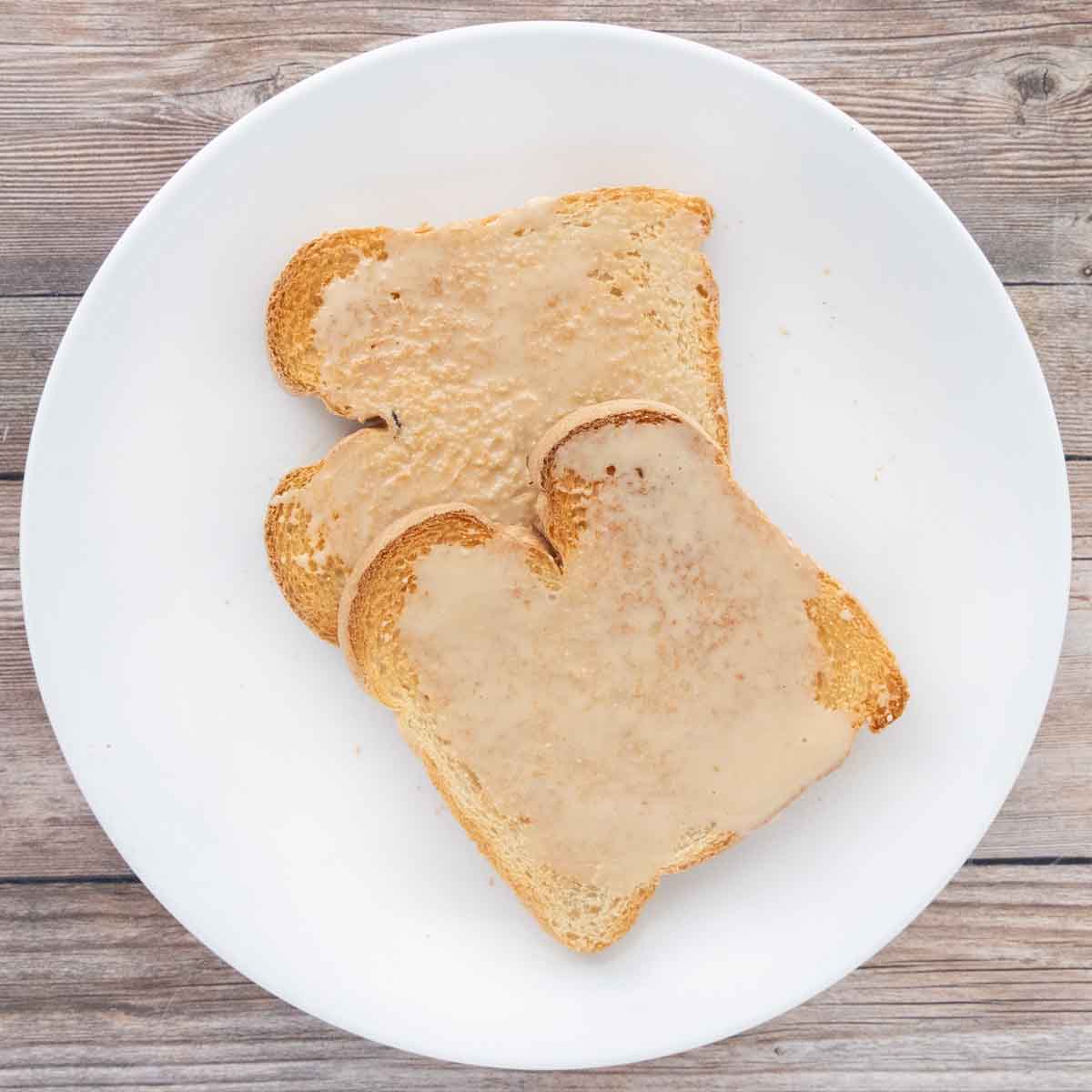 Whipped honey on toast on a white plate.