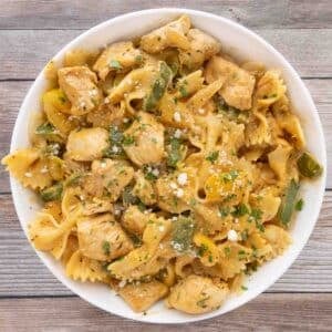 creamy cajun chicken pasta in a white bowl.