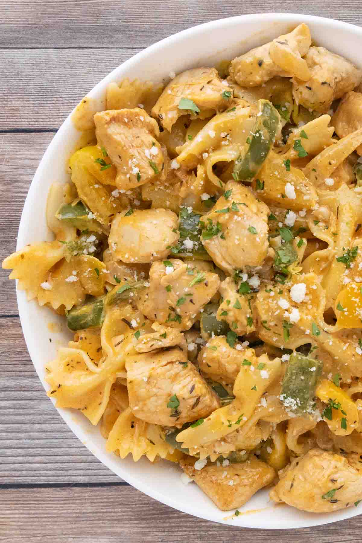 creamy cajun chicken pasta in a white bowl.